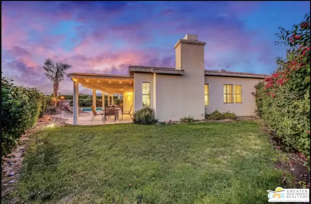 a view of swimming pool with outdoor seating and plants