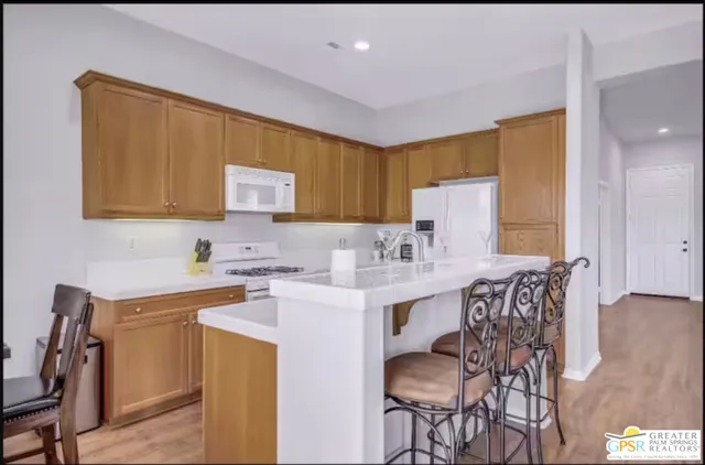 a large kitchen with a table and chairs