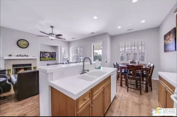 a kitchen with a refrigerator a stove a sink and cabinets