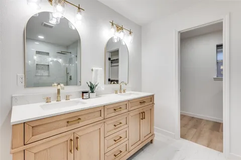 a bathroom with double sink and a mirror