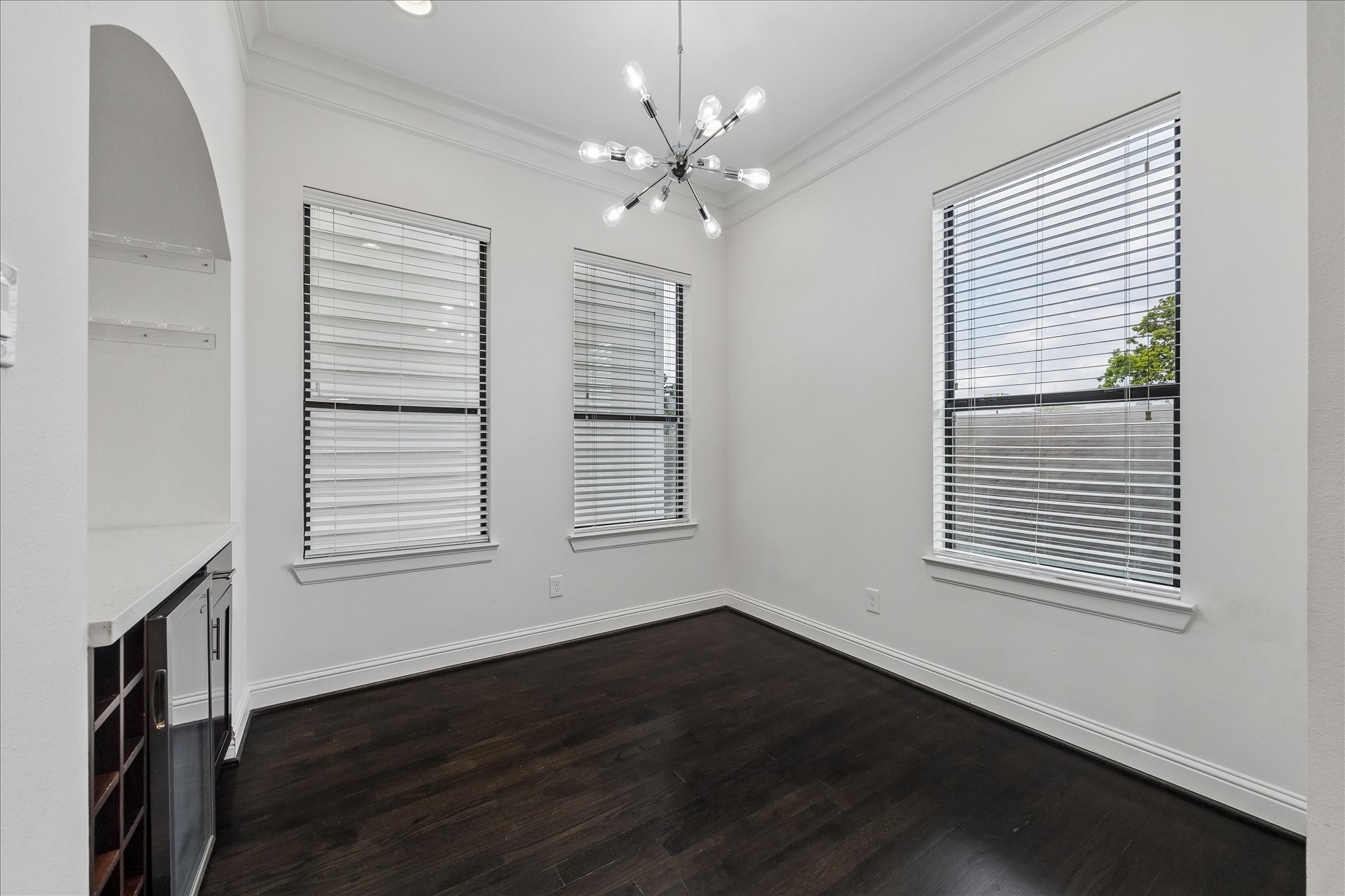 734 West 20th Street, Unit A Houston, TX 77008 - Photo 11 of 23 Dedicated dining area w/ crown molding & designer lighting, complemented by a built-in bar featuring a wine chiller, wine storage & soft-close cabinetry, great for hosting & everyday use.