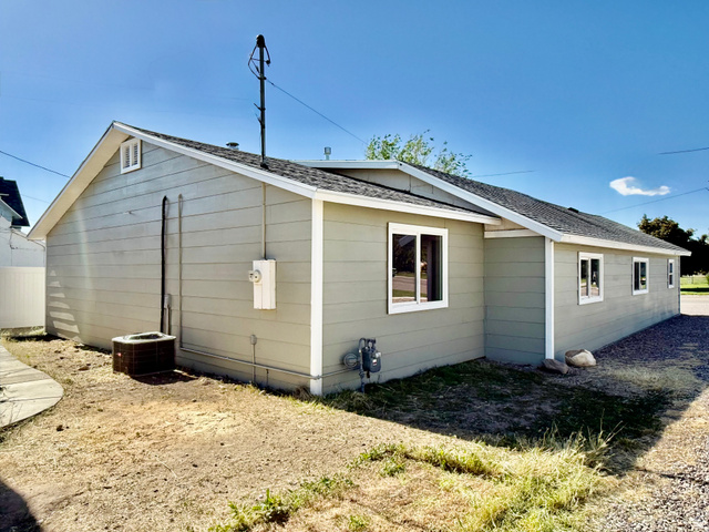 255 West Main Street Mount Pleasant, UT 84647 - Photo 34 of 35 Exterior featuring horizontal siding, white trim, a gabled roofline, and multiple windows