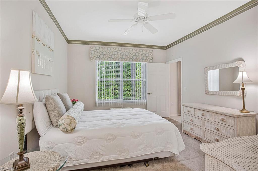 6605 Huntington Lakes Circle, Unit 103 Naples, FL 34119 - Photo 16 of 30 a bedroom with a bed and window