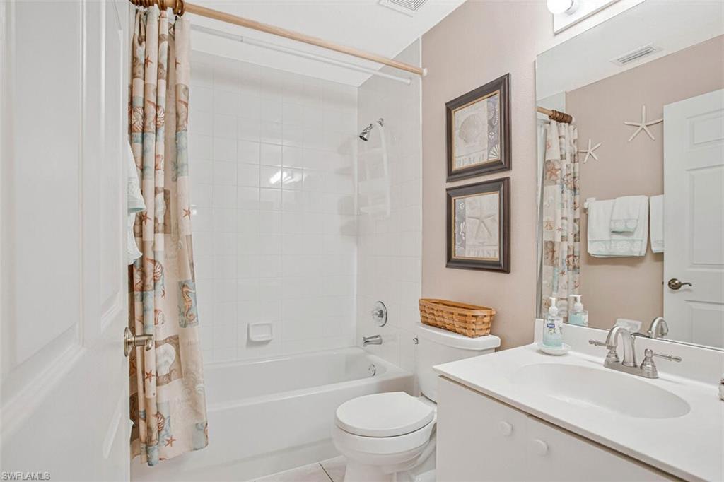 6605 Huntington Lakes Circle, Unit 103 Naples, FL 34119 - Photo 22 of 30 a bathroom with a sink a toilet and shower