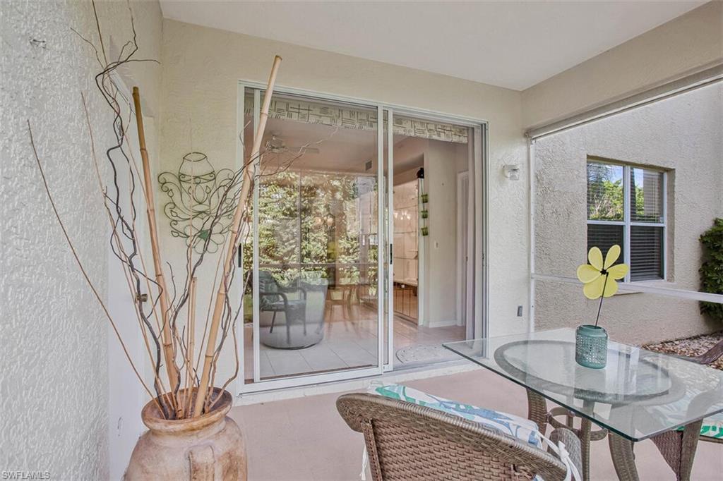 6605 Huntington Lakes Circle, Unit 103 Naples, FL 34119 - Photo 24 of 30 a living room with furniture and a table