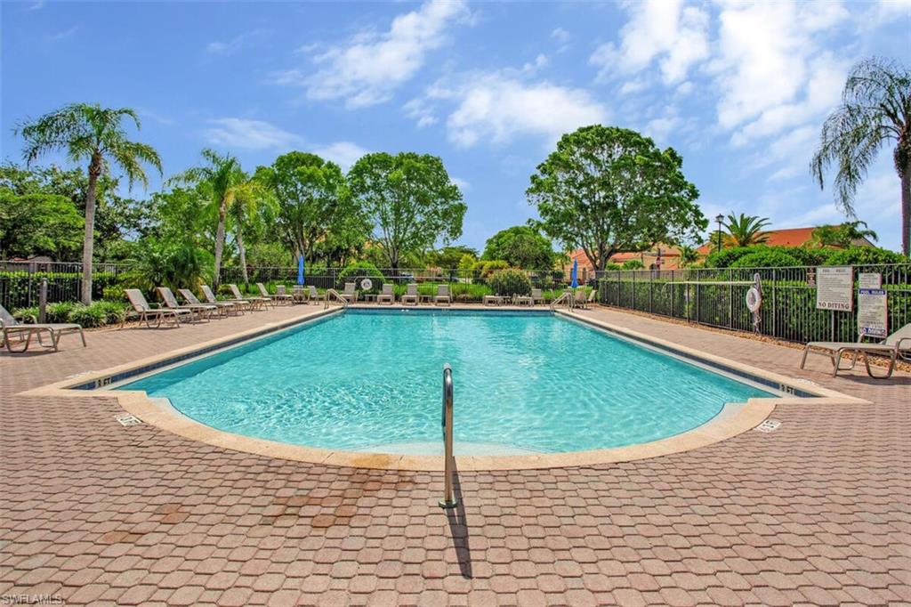 6605 Huntington Lakes Circle, Unit 103 Naples, FL 34119 - Photo 26 of 30 a view of a swimming pool with a yard