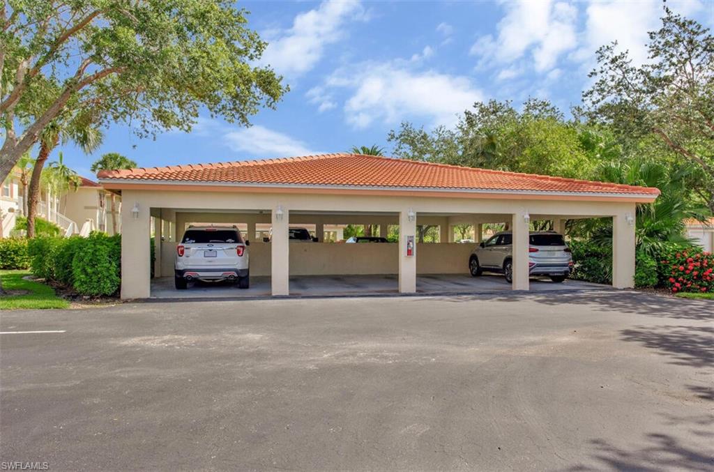 6605 Huntington Lakes Circle, Unit 103 Naples, FL 34119 - Photo 30 of 30 a view of a house with a garden and pathway