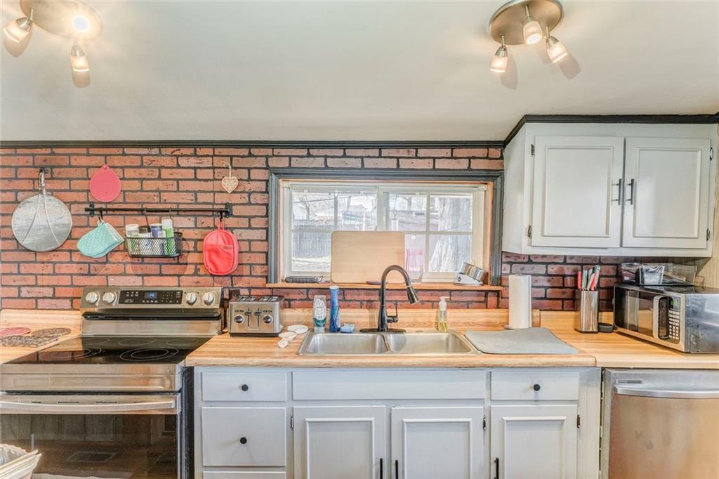 30 Oak Street Aragon, GA 30104 - Photo 18 of 38 a kitchen with granite countertop a sink and a stove