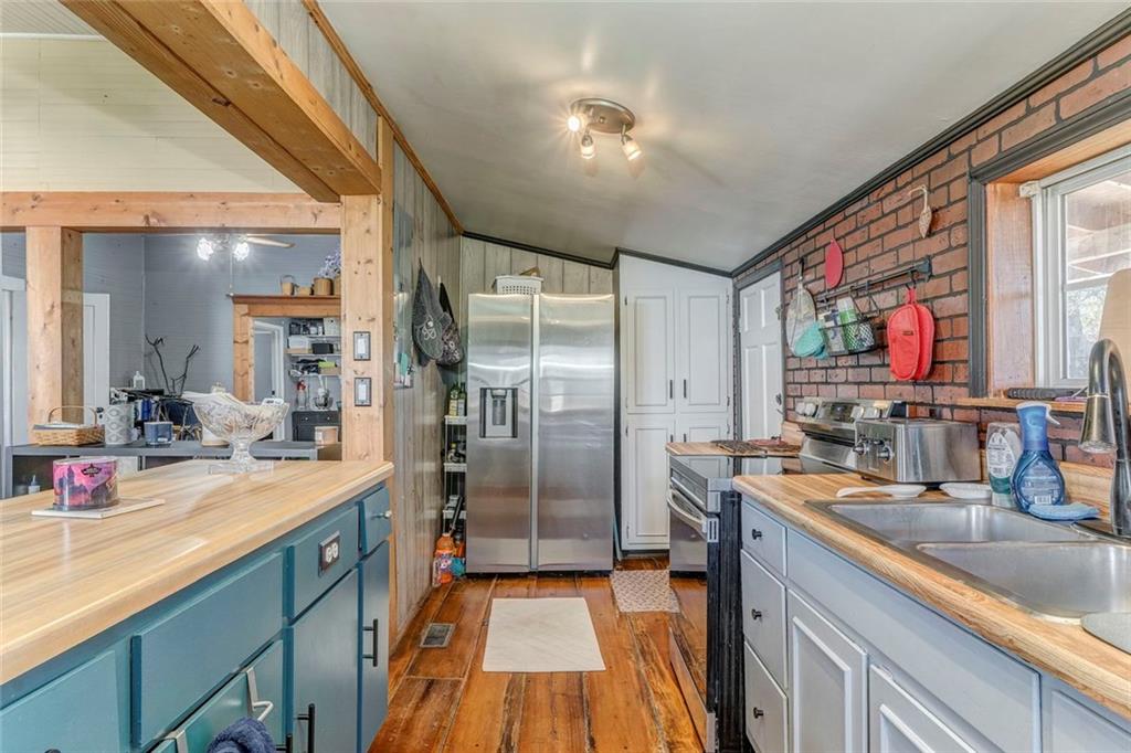 30 Oak Street Aragon, GA 30104 - Photo 20 of 38 a kitchen with stainless steel appliances granite countertop a sink and a refrigerator