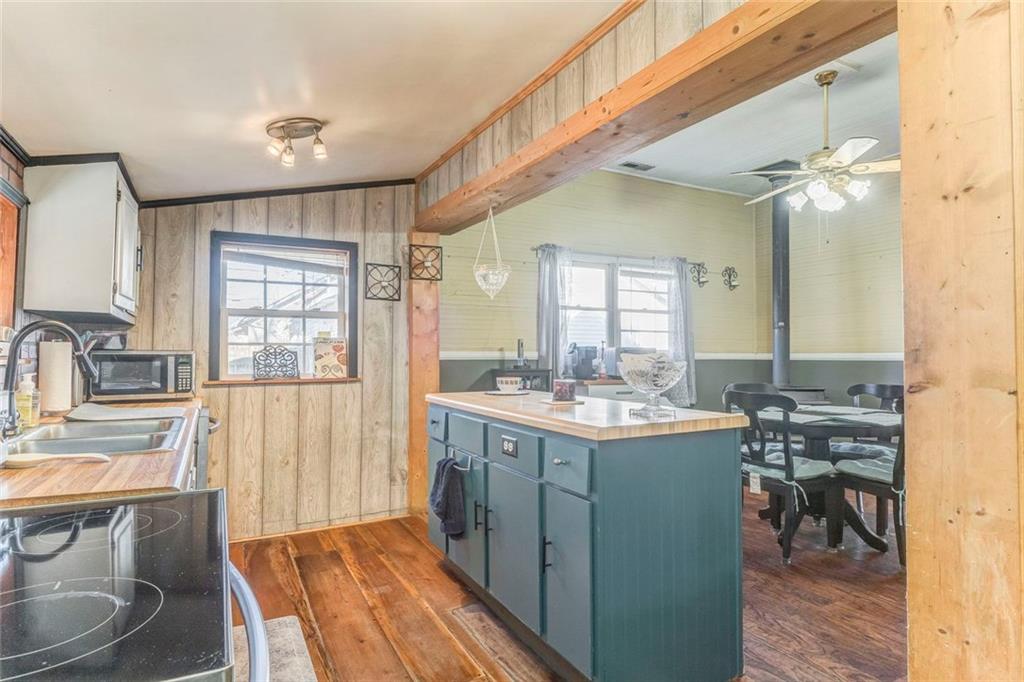 30 Oak Street Aragon, GA 30104 - Photo 21 of 38 a kitchen with a sink a stove cabinets and dining table
