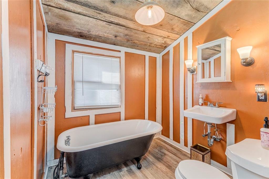 30 Oak Street Aragon, GA 30104 - Photo 26 of 38 a bathroom with a sink a toilet a mirror and a tub