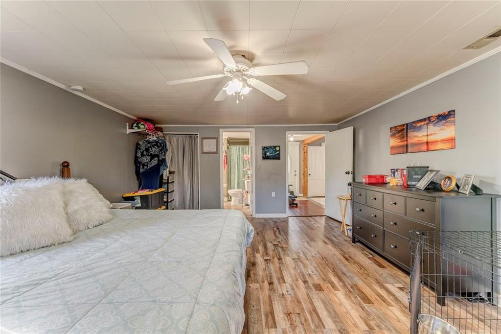 30 Oak Street Aragon, GA 30104 - Photo 29 of 38 a bed room with a bed and a chandelier