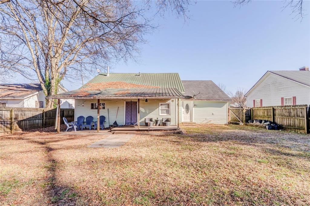 30 Oak Street Aragon, GA 30104 - Photo 34 of 38 a front view of a building with large trees and playing area