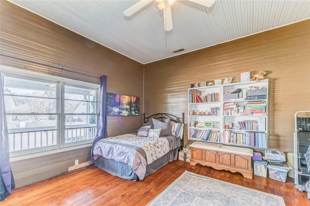 30 Oak Street Aragon, GA 30104 - Photo 8 of 38 a bedroom with a bed a dresser and a large window