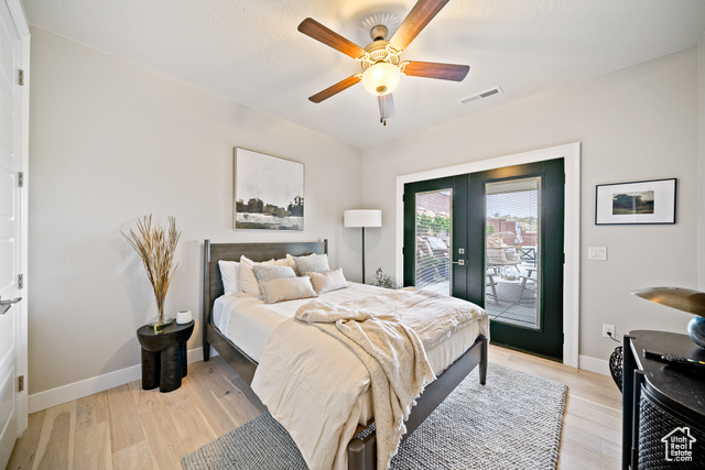 6026 Zen Trail Way St. George, UT 84790 - Photo 25 of 41 Bedroom with access to outside, french doors, light wood-style floors, and a ceiling fan