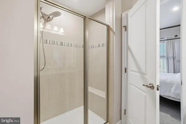 a bathroom with a glass door shower and a sink