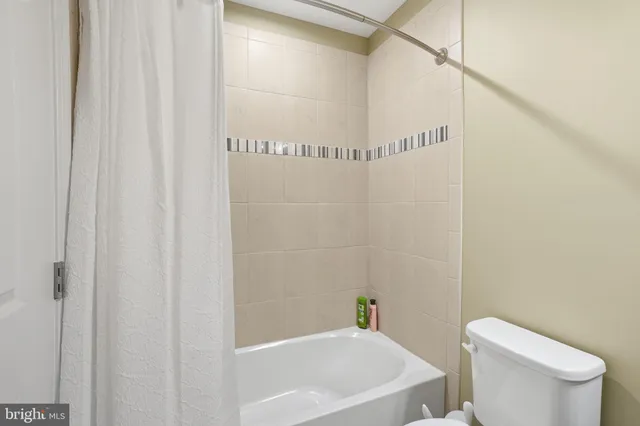 a white bath tub sitting next to a white toilet