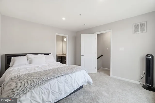 a bedroom with a bed and a television