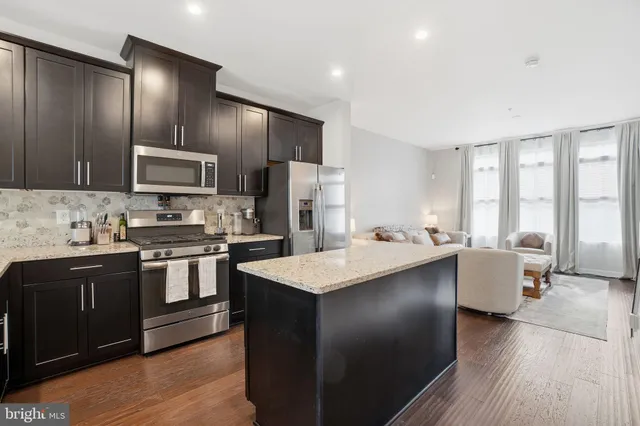 a kitchen with a sink appliances and cabinets