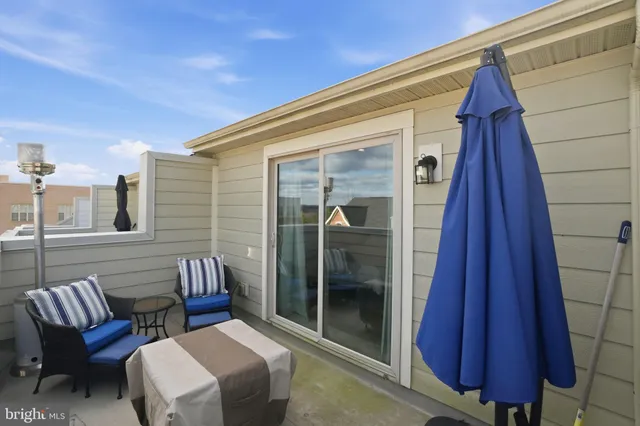 a view of a balcony with furniture and wooden floor