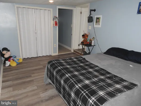 a bedroom with a bed and dresser