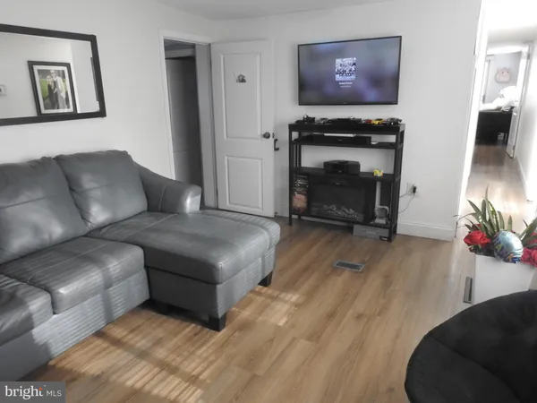 a kitchen with sink a microwave a stove and cabinets