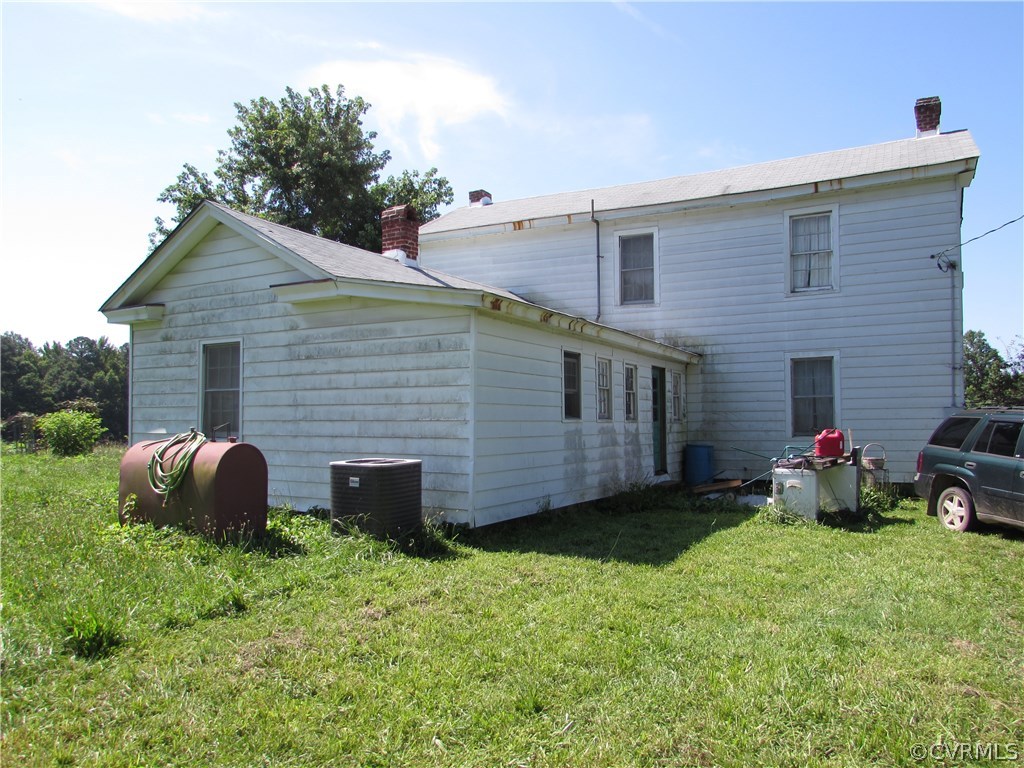 6422 White Oak Road Wilsons, VA 23894 - Photo 2 of 6 a backyard of a house with wooden fence and a toy car
