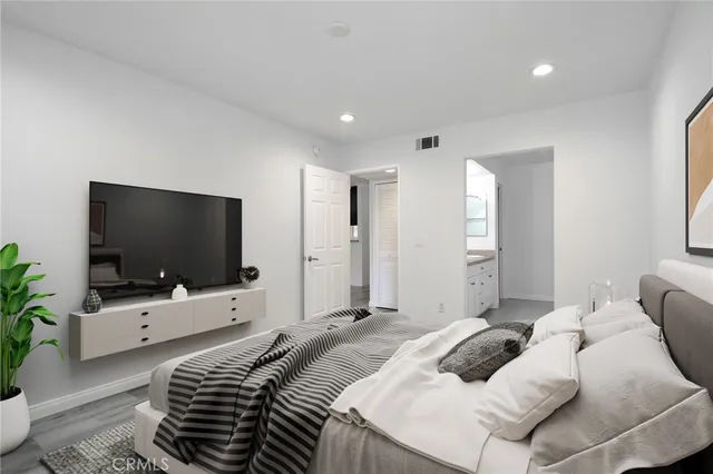 a bedroom with a bed and a flat screen tv