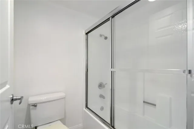 a bathroom with a shower and a toilet