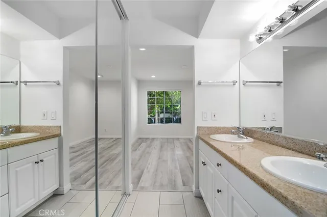 a bathroom with a granite countertop sink mirror and double