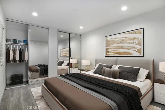 a bedroom with bed and a chandelier