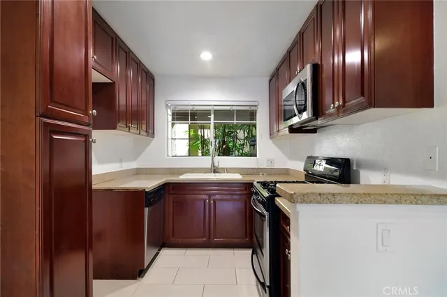 a kitchen with stainless steel appliances granite countertop a sink and a stove