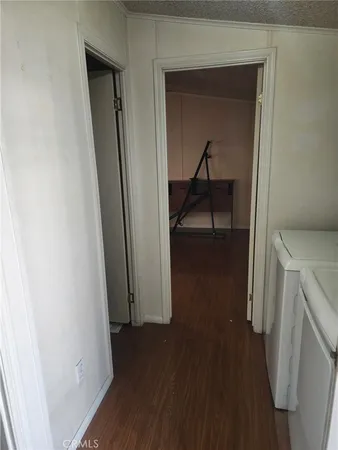 a view of a hallway with wooden floor and a hallway