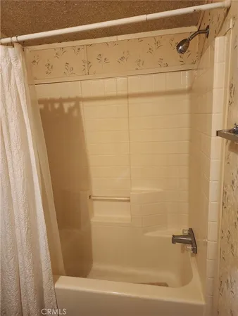 a bathroom with a shower and a bath tub