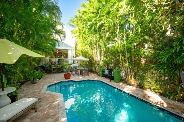 a swimming pool with outdoor seating and yard