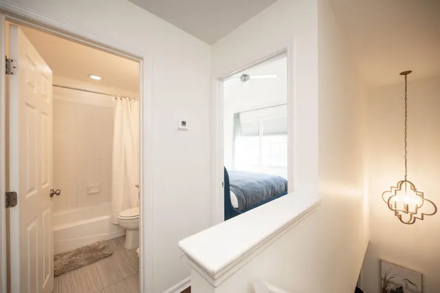 a bathroom with a tub shower and sink