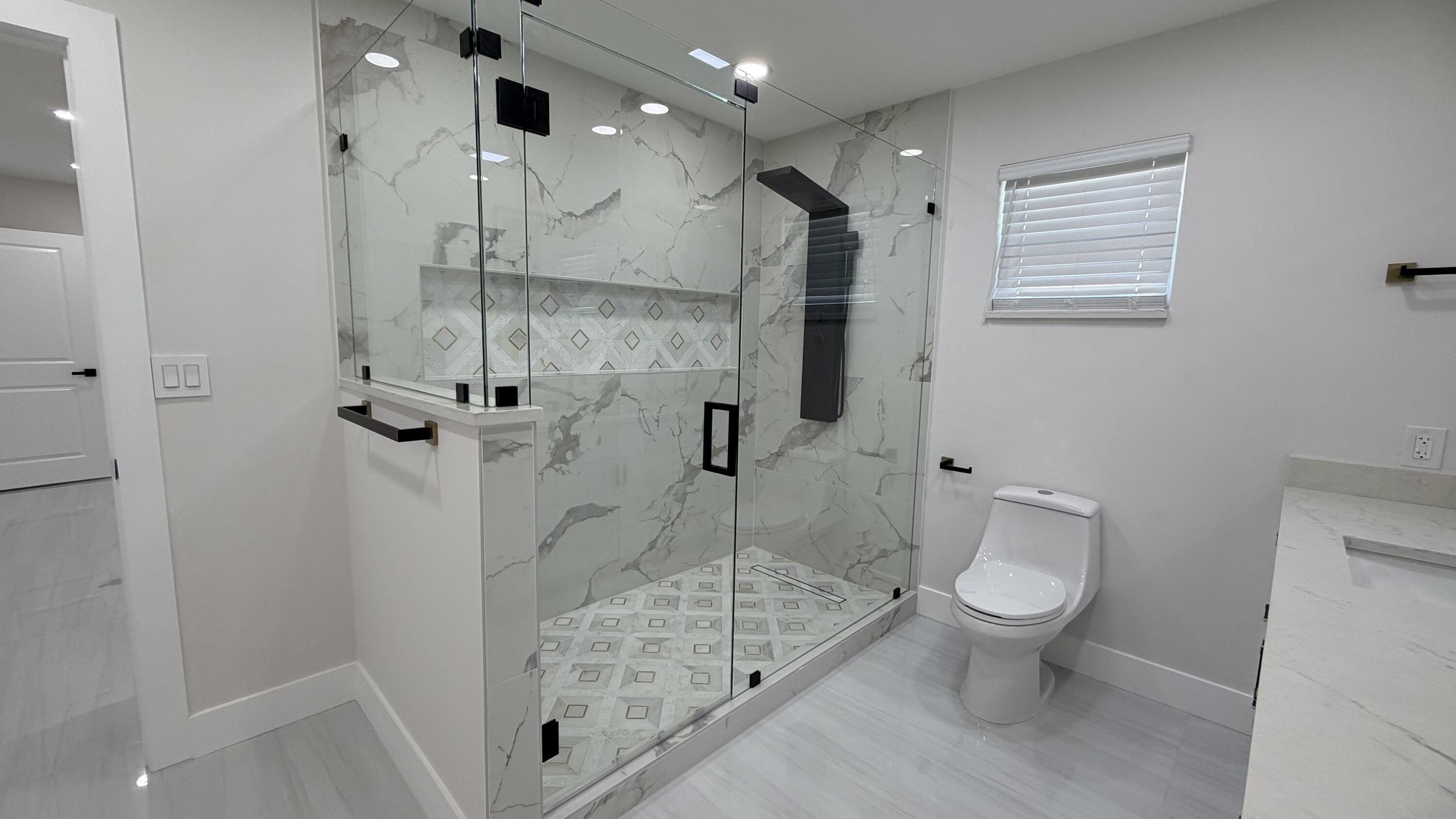 2521 Northeast 45th Street Lighthouse Point, FL 33064 - Photo 15 of 25 a bathroom with a granite countertop sink toilet and shower