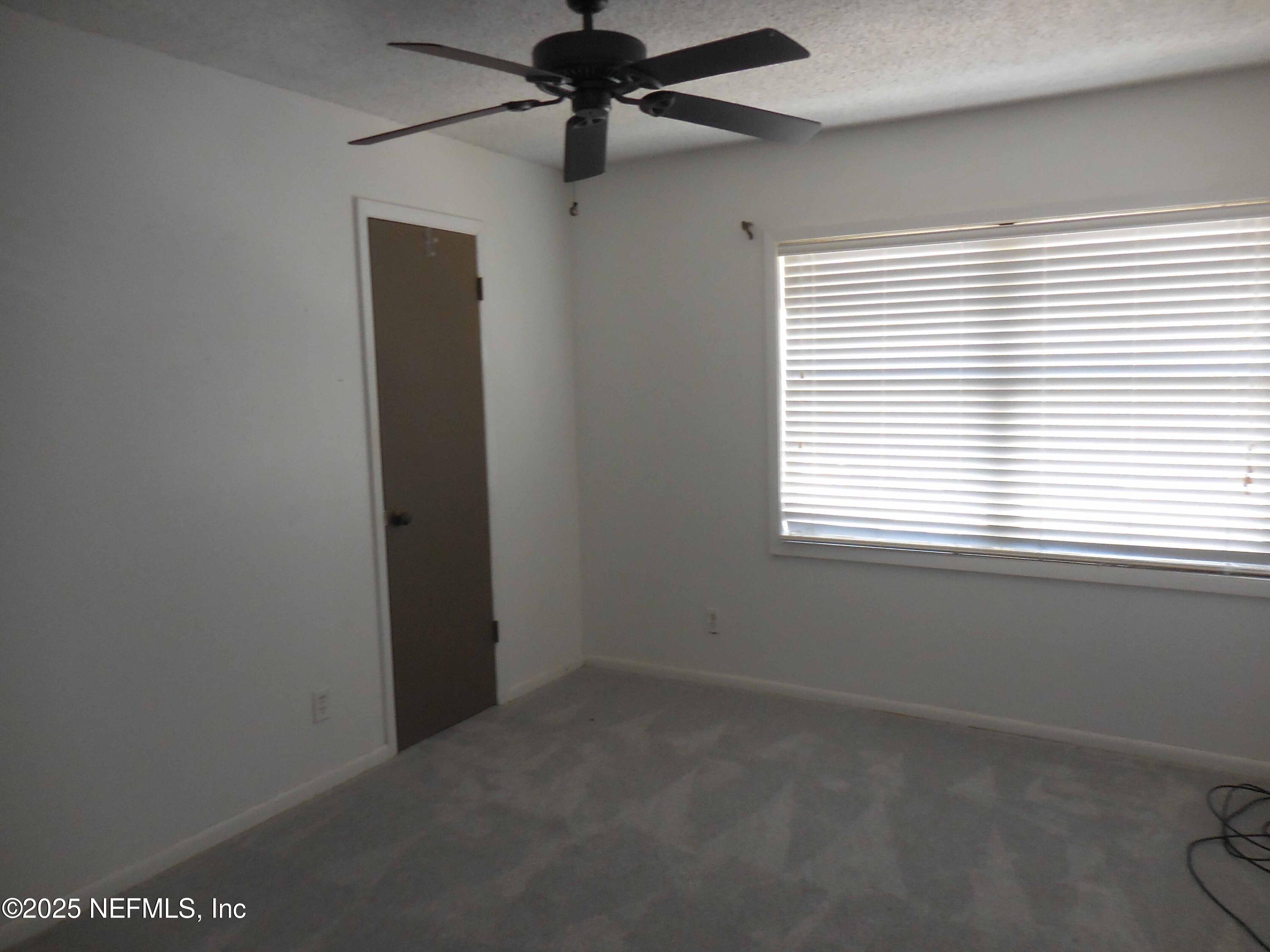 695 A1A North, Unit 23 Ponte Vedra Beach, FL 32082 - Photo 12 of 22 an empty room with a window and a fan
