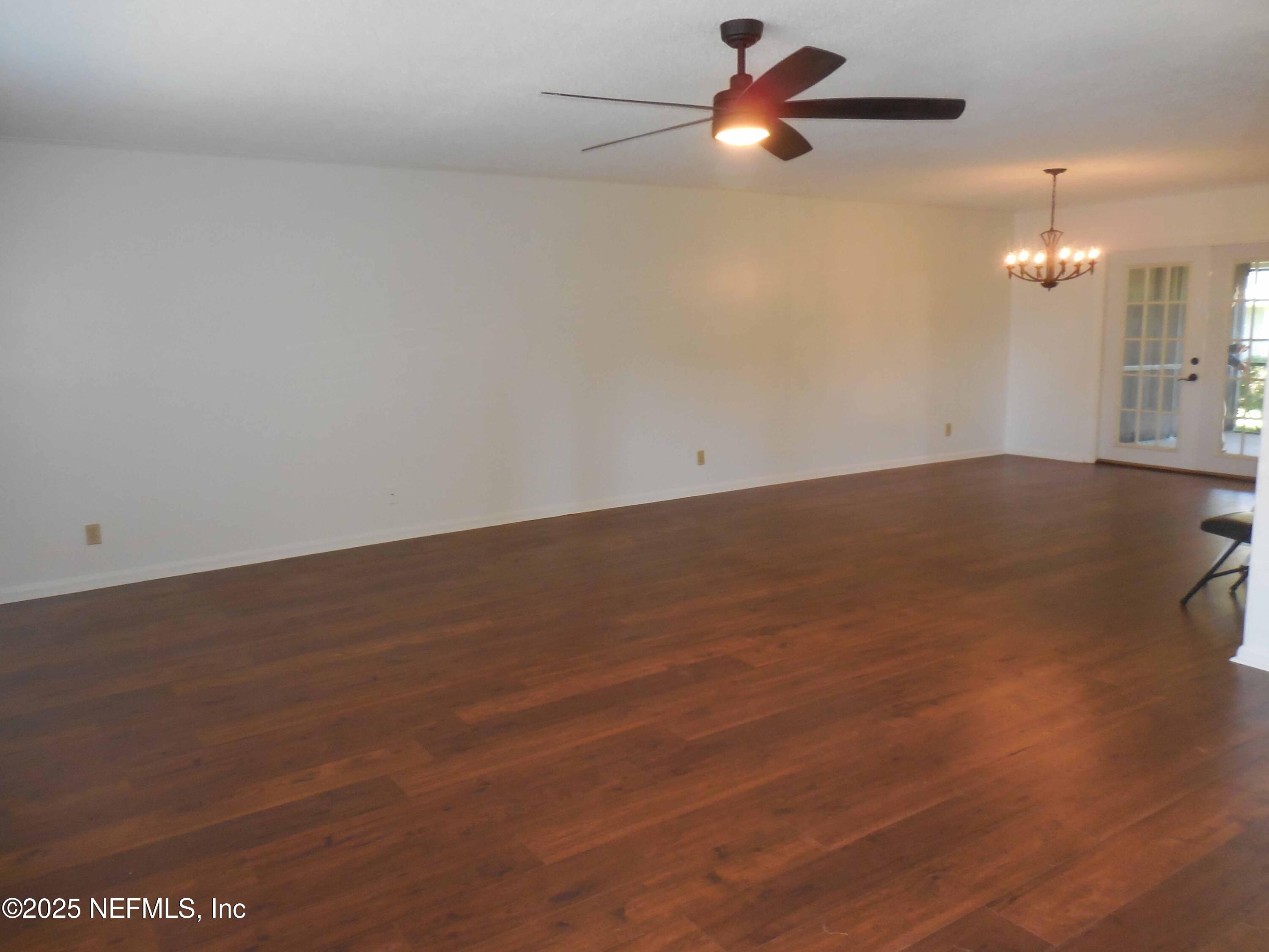 695 A1A North, Unit 23 Ponte Vedra Beach, FL 32082 - Photo 3 of 22 an empty room with a empty space and a ceiling fan