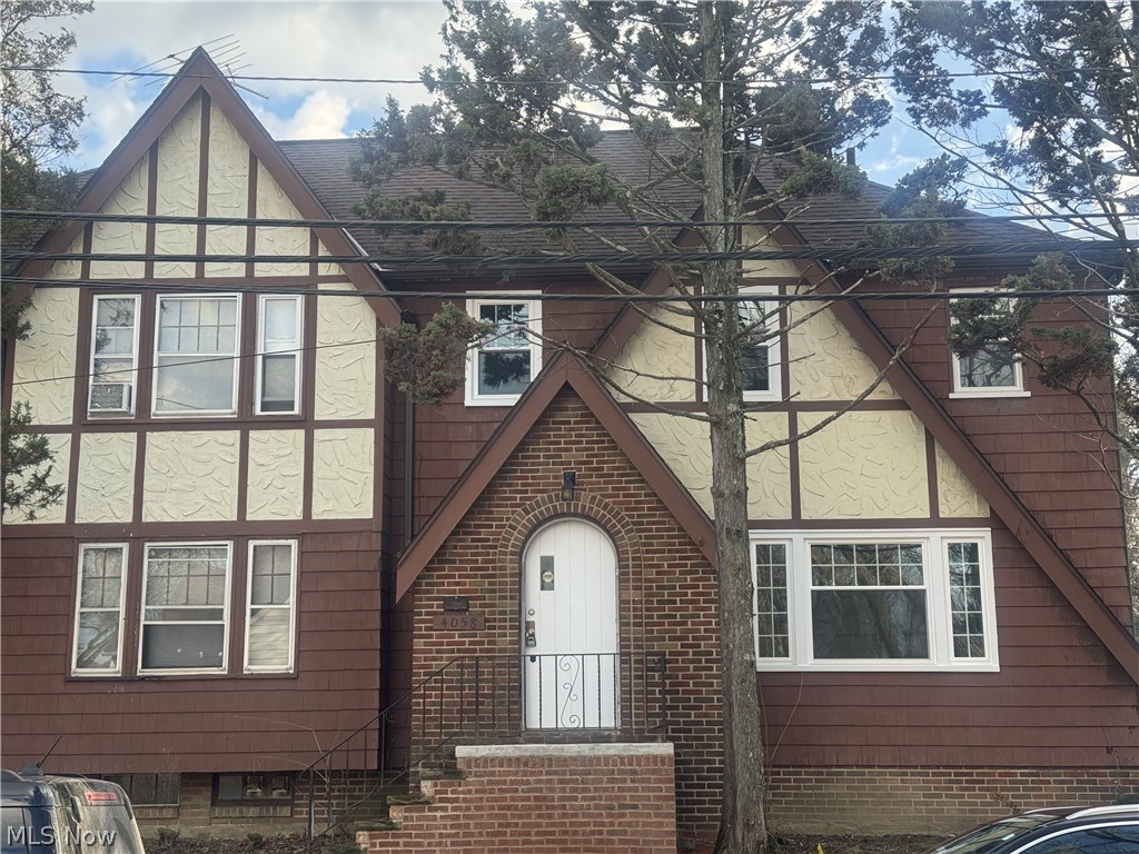 4058 Ardmore Road Cleveland, OH 44121 - Photo 1 of 14 View of front facade with a shingled roof, brick siding, and stucco siding