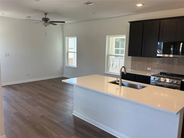a room with pool table and windows