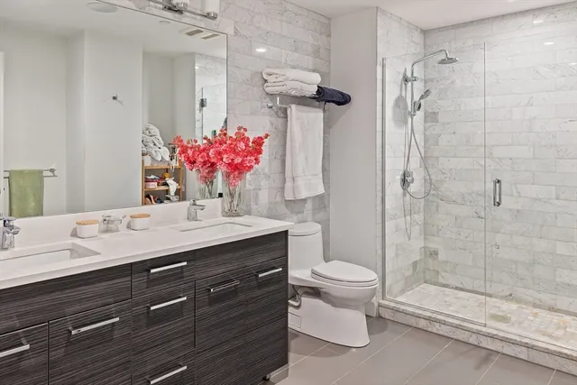 a bathroom with a sink toilet and shower