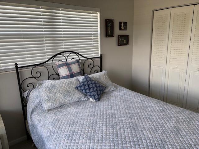 313 Dorset H, Unit 313 Boca Raton, FL 33434 - Photo 15 of 20 a bedroom with a bed and a window