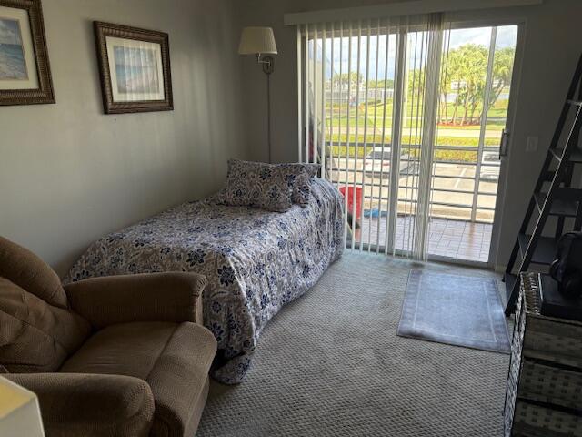 313 Dorset H, Unit 313 Boca Raton, FL 33434 - Photo 17 of 20 a bedroom with a bed couch and a large window