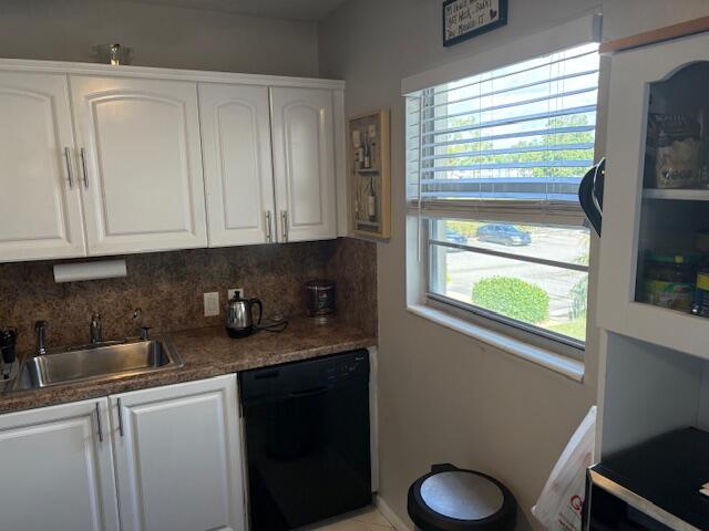313 Dorset H, Unit 313 Boca Raton, FL 33434 - Photo 2 of 20 a kitchen with stainless steel appliances granite countertop white cabinets and a window