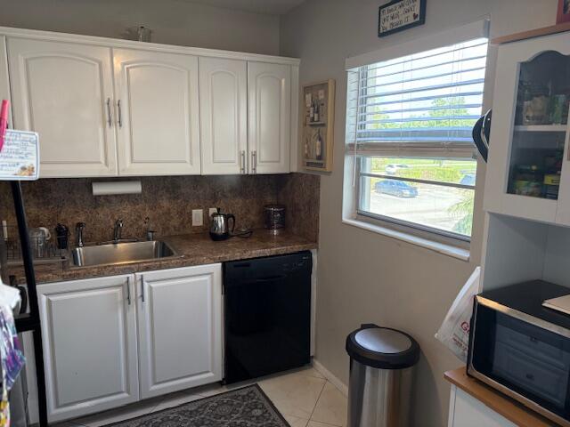 313 Dorset H, Unit 313 Boca Raton, FL 33434 - Photo 3 of 20 a kitchen with stainless steel appliances a sink stove and cabinets