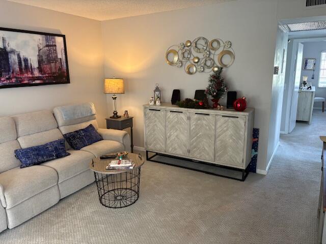 313 Dorset H, Unit 313 Boca Raton, FL 33434 - Photo 9 of 20 a living room with furniture and a couch