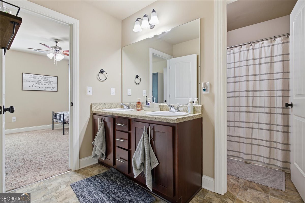 440 Creekside Park Covington, GA 30014 - Photo 32 of 57 a bathroom with a double vanity sink and a mirror