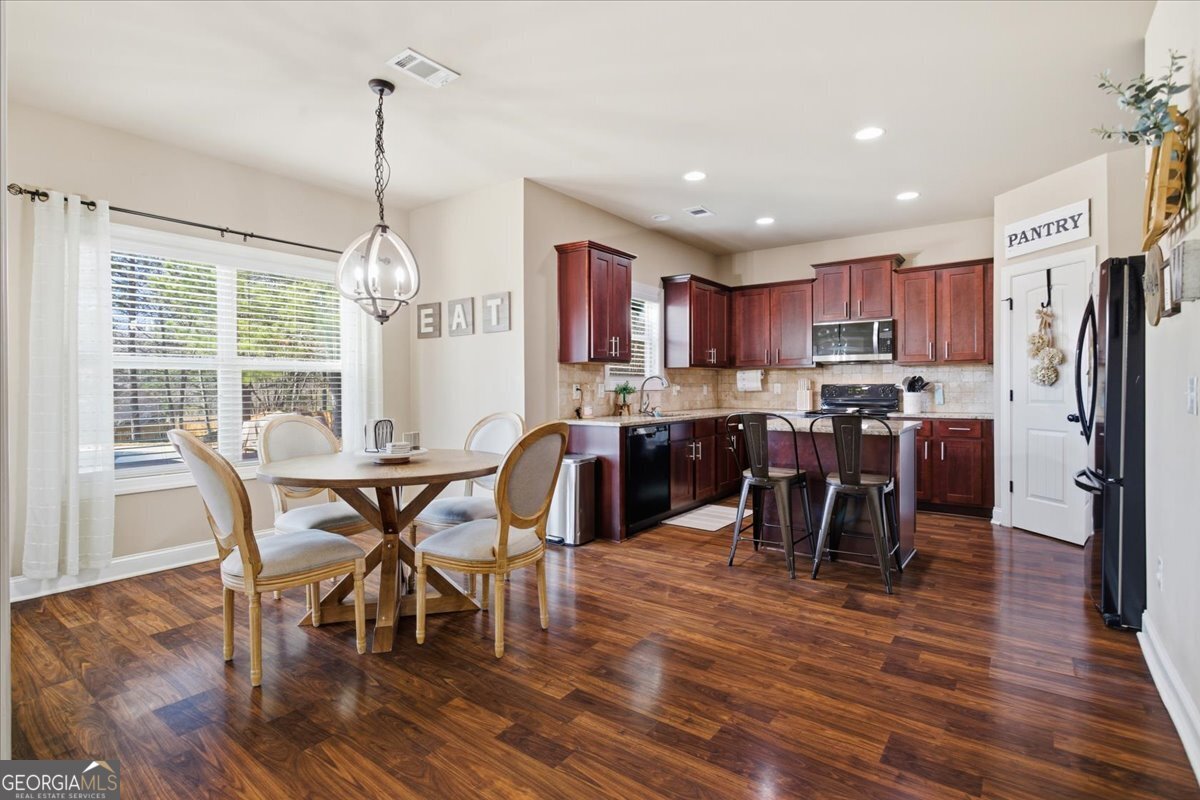 440 Creekside Park Covington, GA 30014 - Photo 10 of 57 a view of a dining room with furniture window and wooden floor