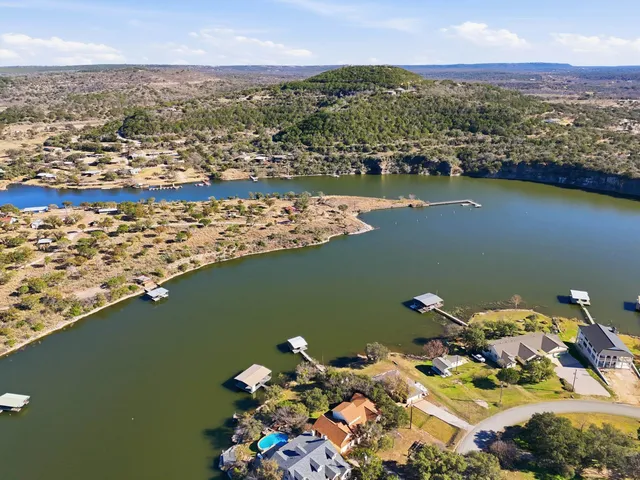 an aerial view of a houses with ocean view